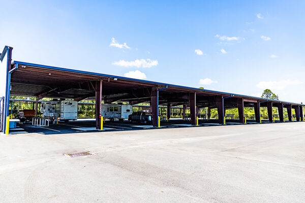 Steel covered parking structure with RVs and trucks