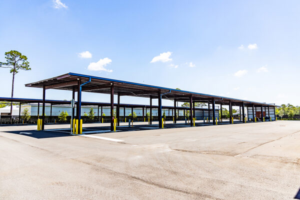 Open-air steel commercial metal building canopy with parking bays