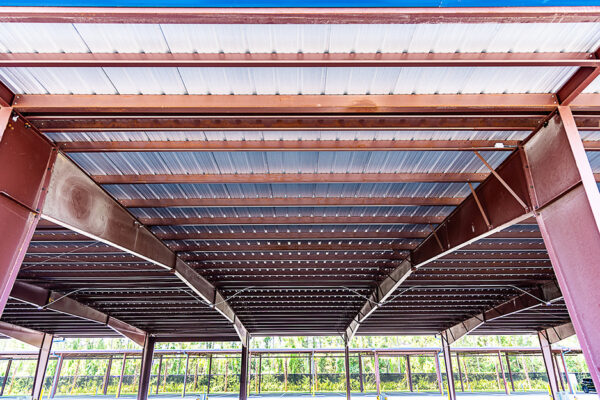 Steel covered riding arena interior with exposed beams