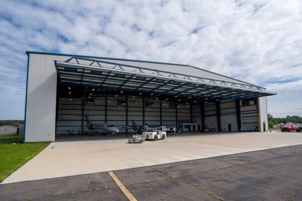 Aircraft hangar with open steel building front