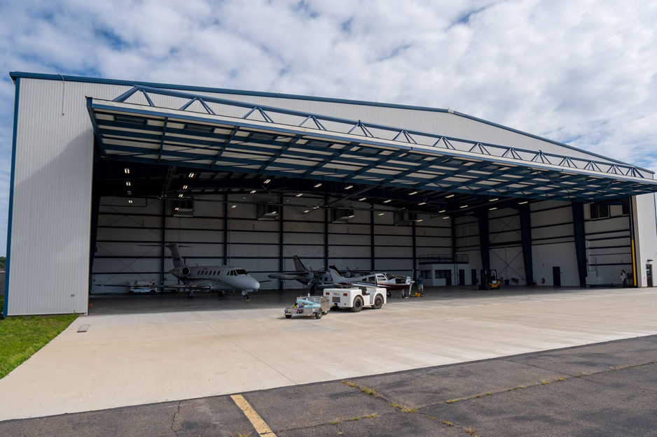 Aircraft hangar with steel building and private jets