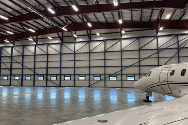 Aircraft hangar inside a steel building with private jet