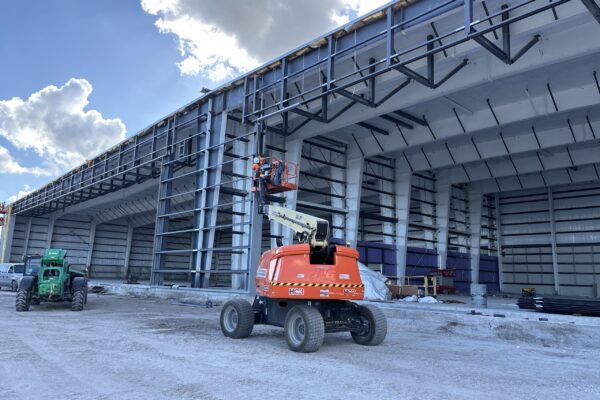 Construction of a large steel building with lift equipment