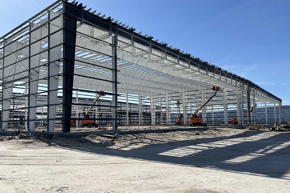 Steel building under construction with lift equipment