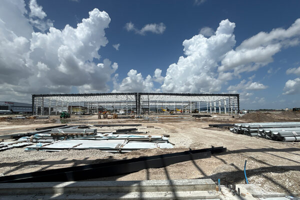 Steel building under construction with metal framing outdoors