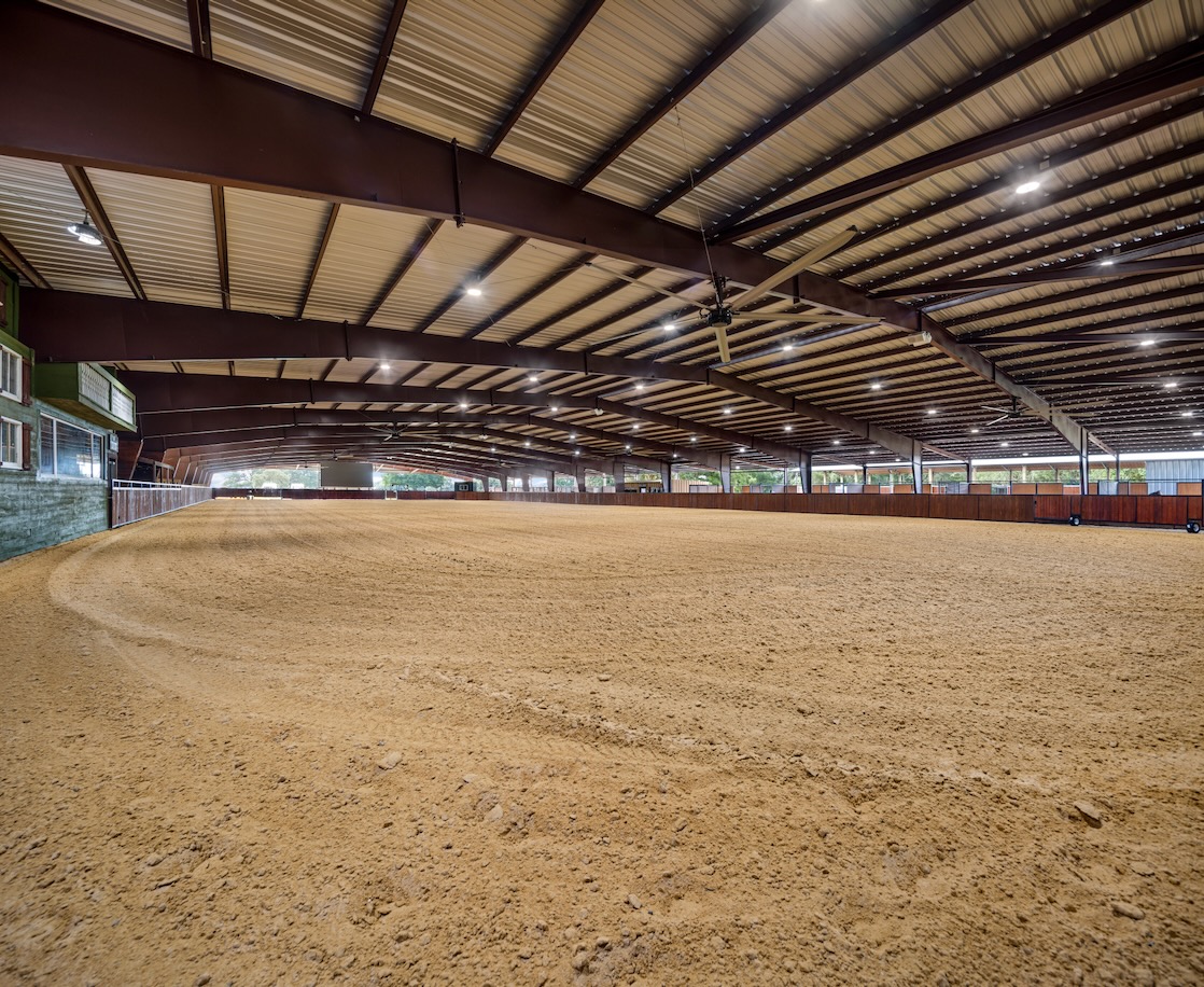 Steel riding arena with spacious covered indoor horse arena and sand footing