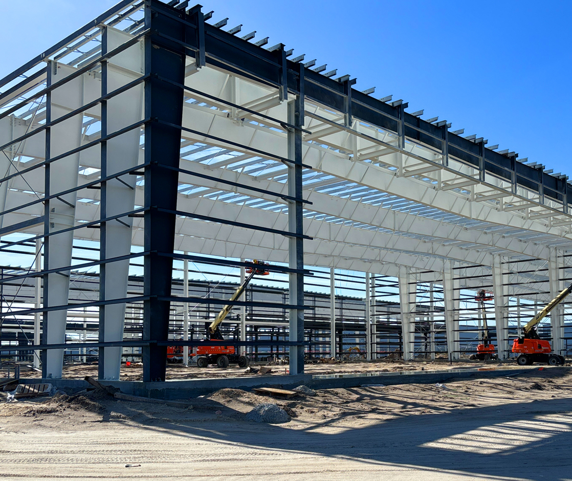 Steel building under construction with steel frame and lift equipment
