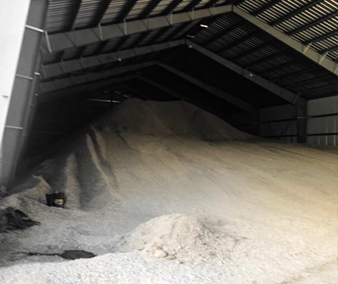 Large steel agricultural building storing bulk grain or feed