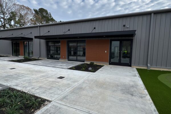 Courtyard lined with glazed garage doors at the Ruby-Collins metal office building in Smyrna, GA