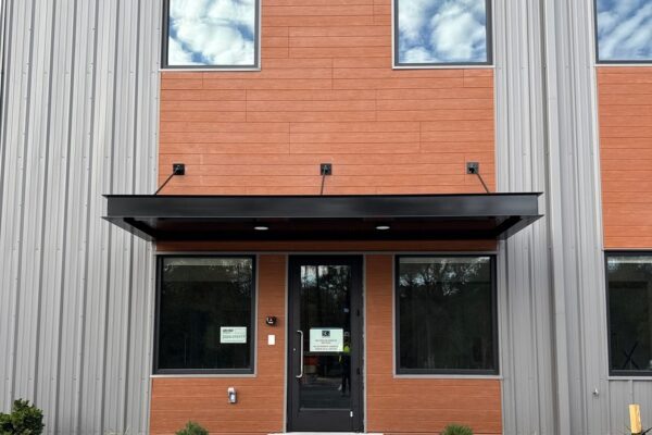 Front entrance of the Ruby-Collins metal office building in Smyrna, GA, finished with fiber cement cladding