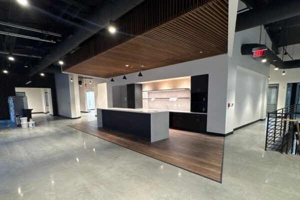 Open office interior with a kitchen island inside the Ruby-Collins metal office building in Smyrna, GA