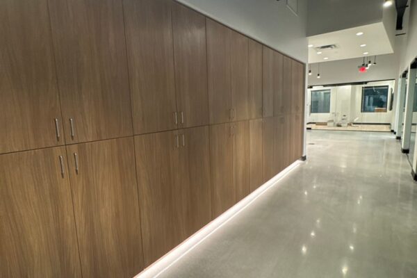 Hallway lined with built-in wood cabinets inside the Ruby-Collins metal office building in Smyrna, GA