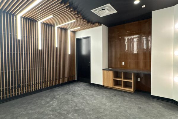 Lounge with wood slat finishes inside the Ruby-Collins metal office building in Smyrna, GA